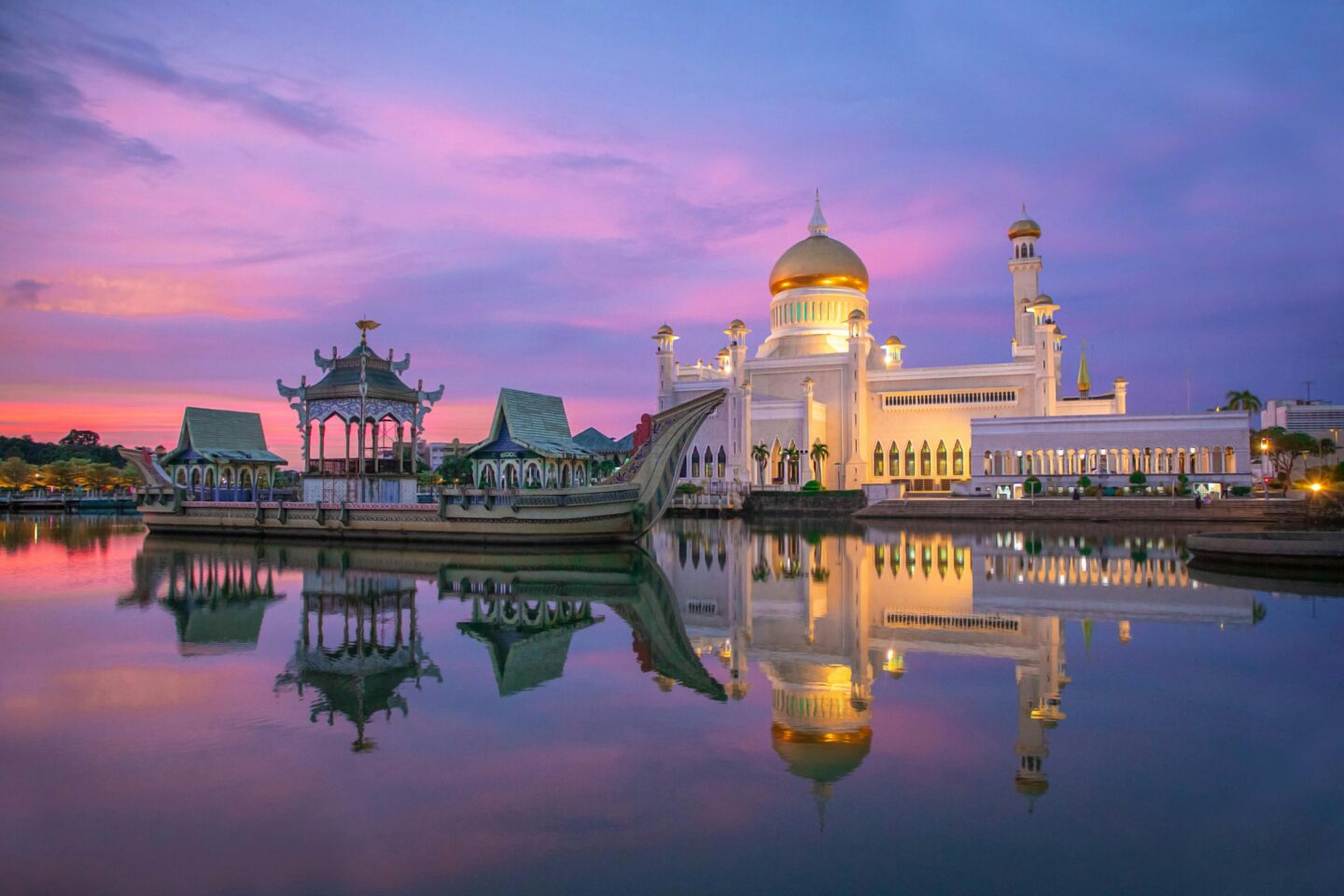 Stunning view of Sultan Omar Ali Saifuddin Mosque reflecting in the water at sunset in Brunei.