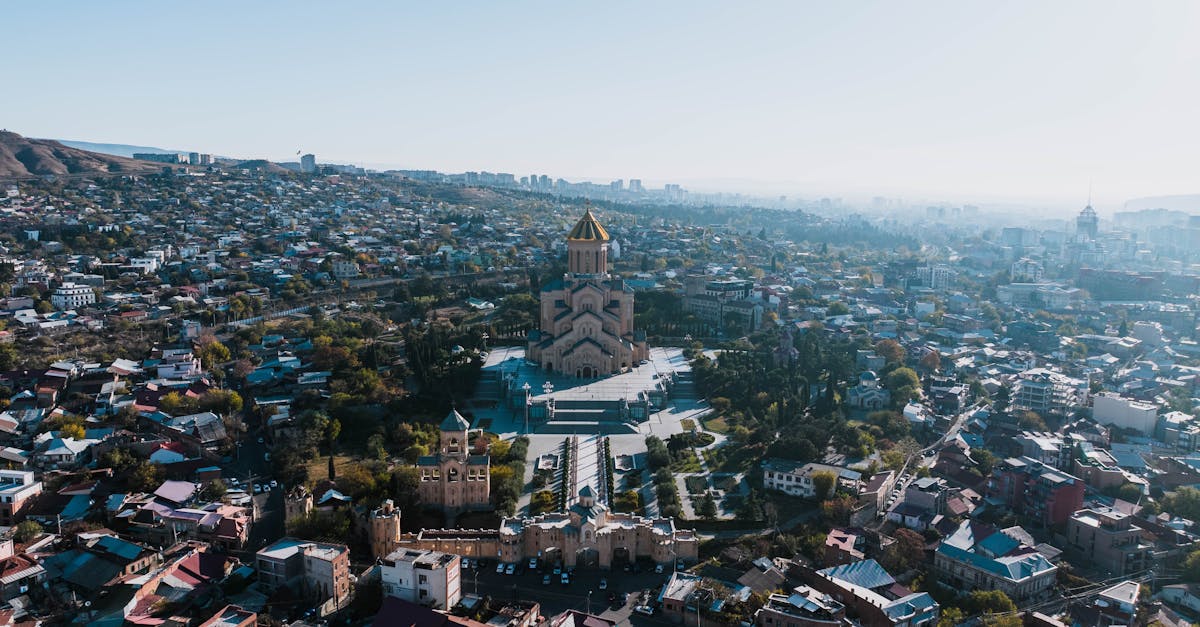 A stunning aerial view capturing the Holy Trinity Cathedral amidst the cityscape of Tbilisi, Georgia.