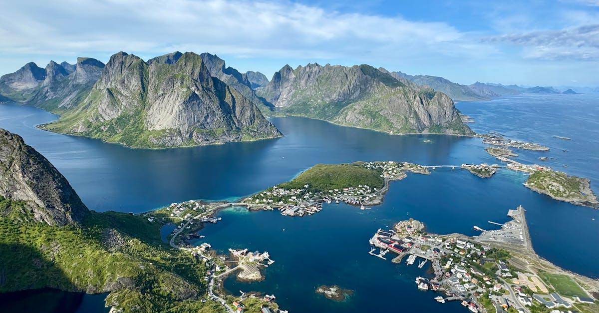 Stunning aerial view of Norwegian fjords in summer with turquoise waters and lush islands.