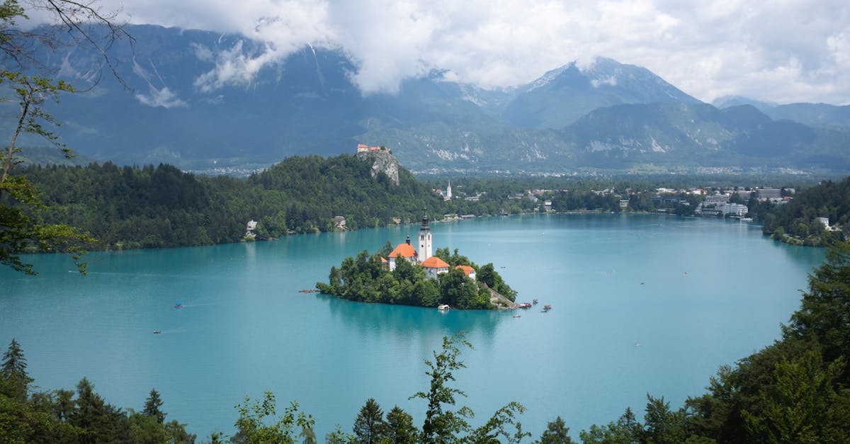 Stunning panoramic view of Lake Bled with its iconic island church and surrounding mountains.