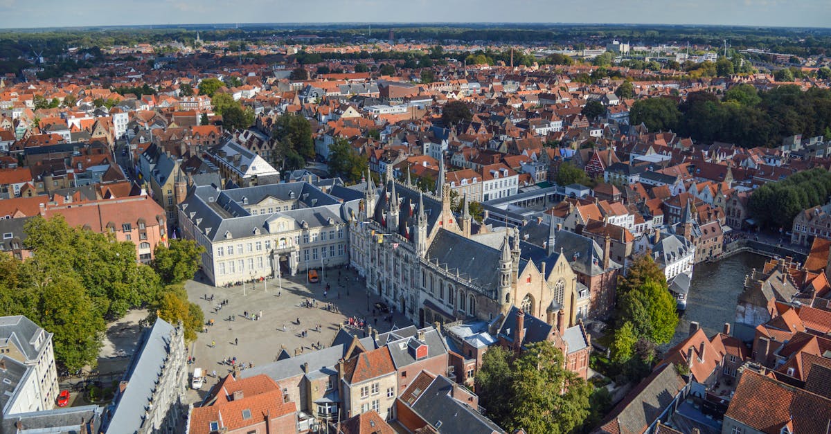From above of historical Bruges City Hall located on Burg Square near canal and aged buildings on sunny day